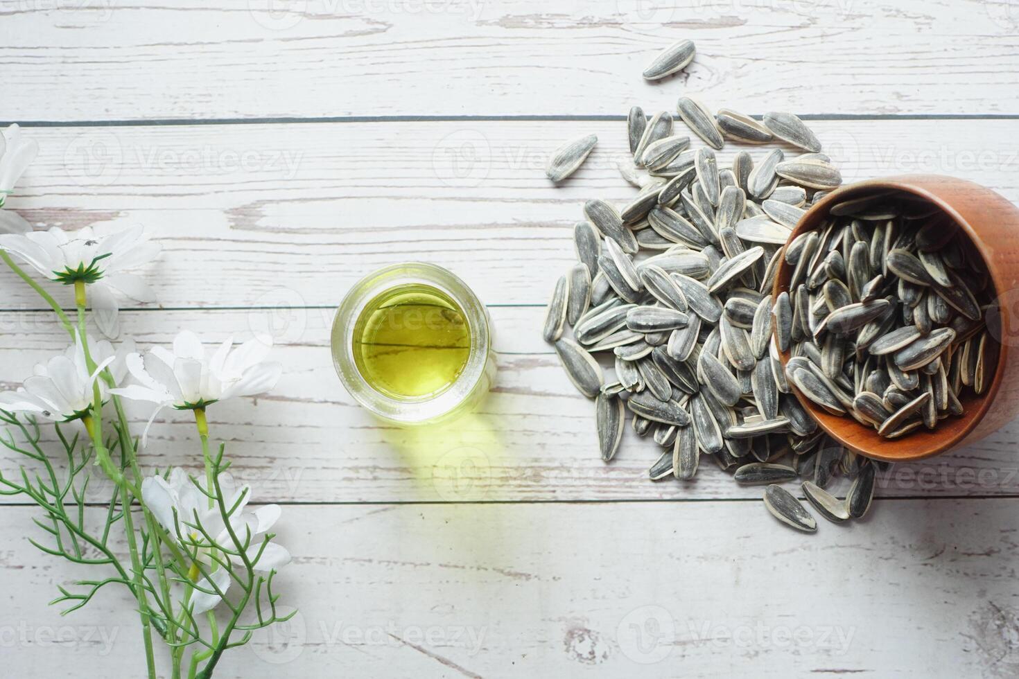 top view of sunflower seeds and oils on table, photo