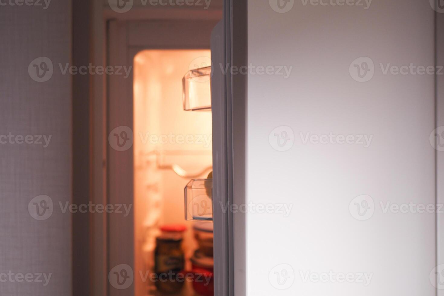 half open fridge with food and vegetables , photo