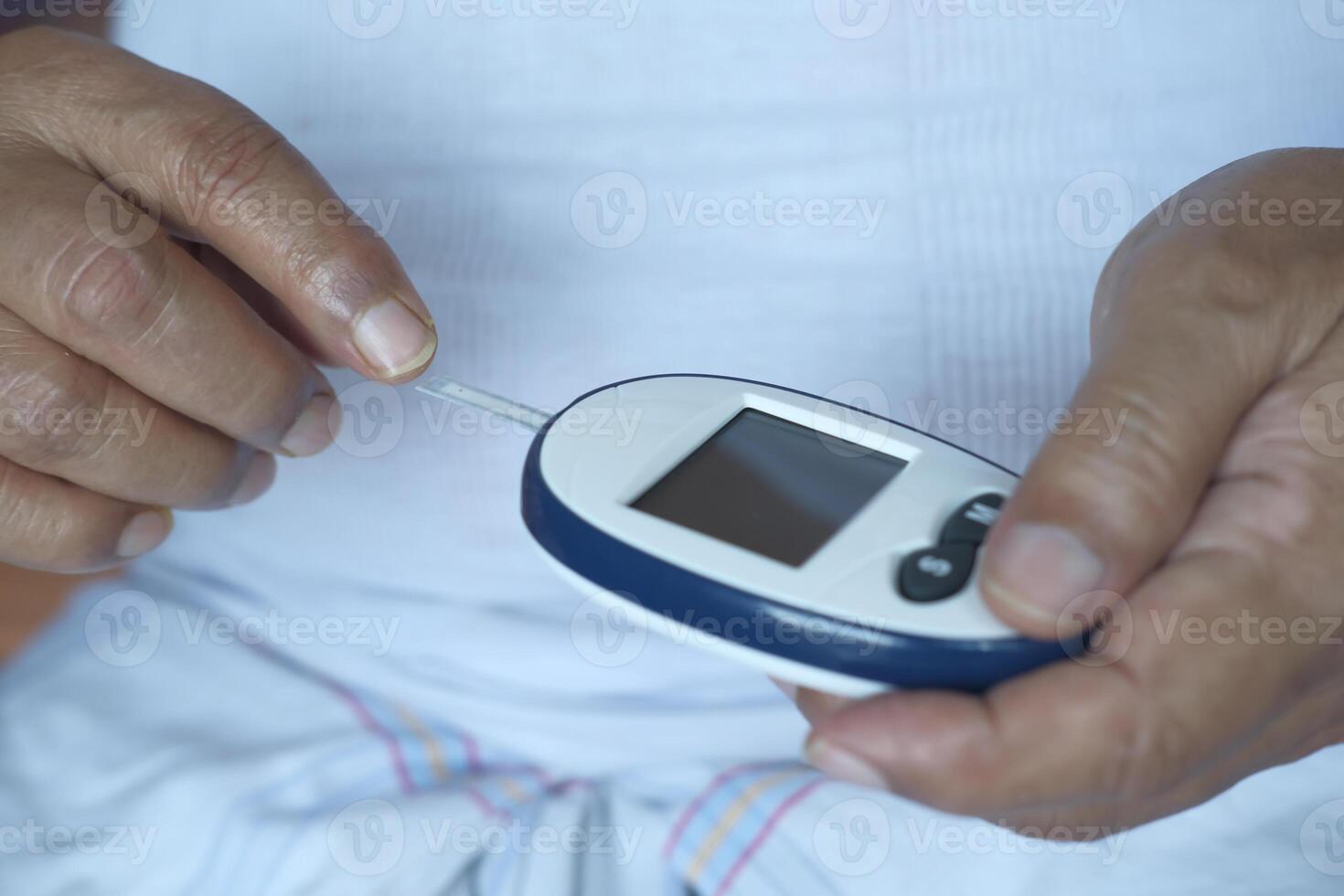 Monitoring blood sugar levels with a glucose meter for diabetes care and health maintenance photo