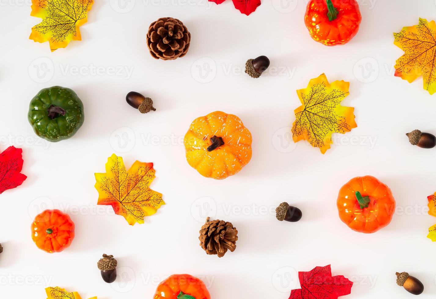 Creative autumn or fall pattern made with colorful fallen leaves, pumpkins, pinecone and nuts on white background. Minimal retro vintage autumn concept. Season nature flat lay. Autumn aesthetic. photo