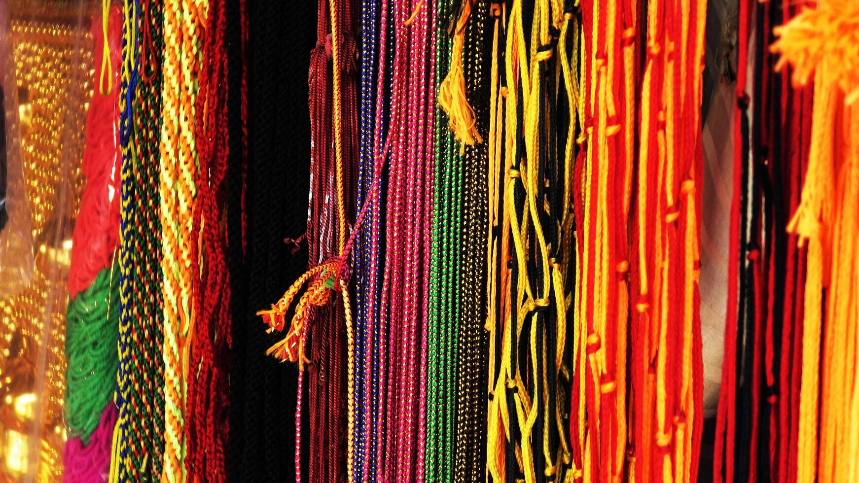 Colorful thread strings used for spiritual purposes displayed in a shop photo