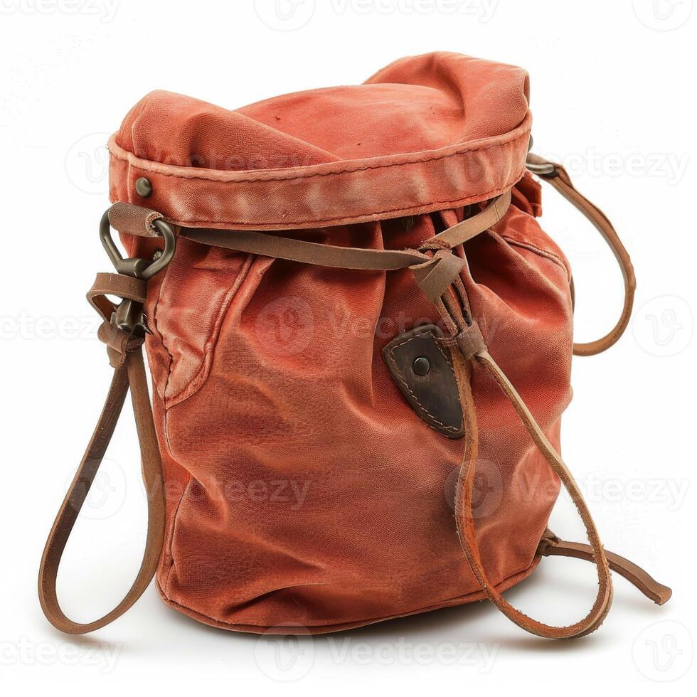 A worn red leather drawstring pouch with brass hardware, showcasing a rustic, vintage appearance on a white background. photo