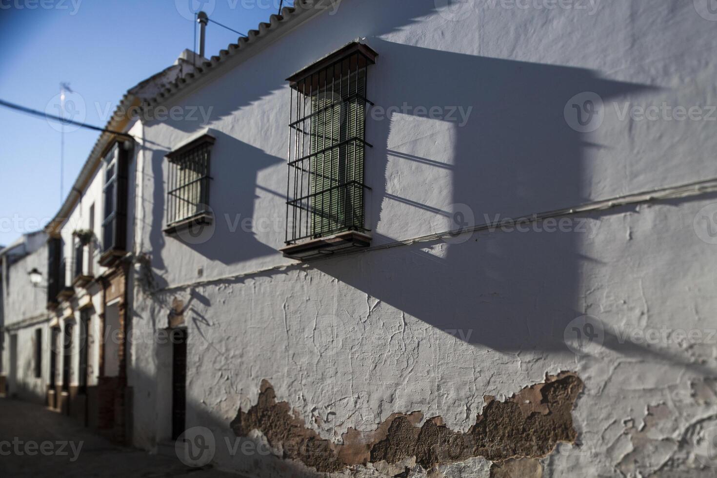 Typical Mediterranean architecture with whitewashed walls and narrow streets in the historical city of Carmona, province of Seville, Spain. Tilted lens used for shallower depth of field. photo