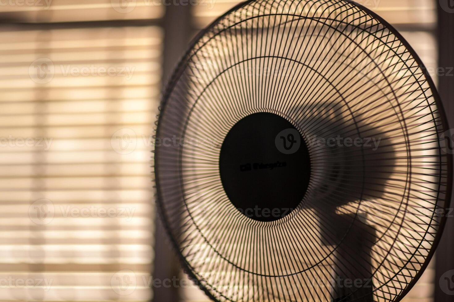 Electric Fan Operating in Cozy Sevilla Room on a Sunny Summer Day photo