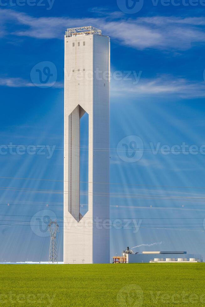 Solar Power Tower in Spanish Countryside Under Blue Sky photo