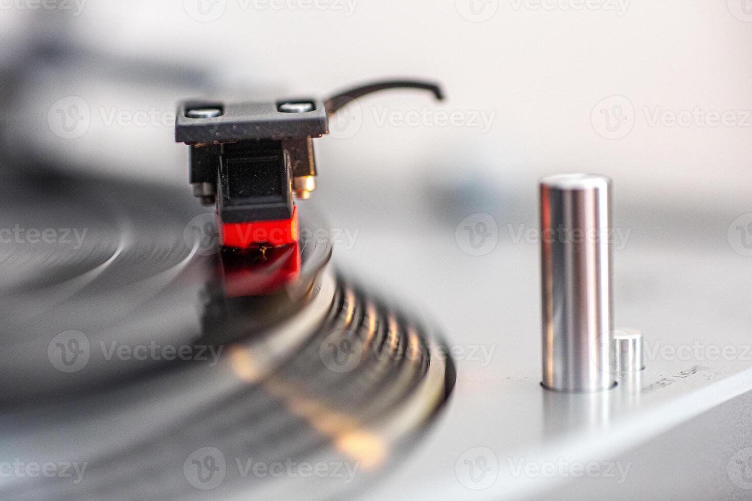 Close Up of Vinyl Record Playing on Turntable in Bright Setting photo