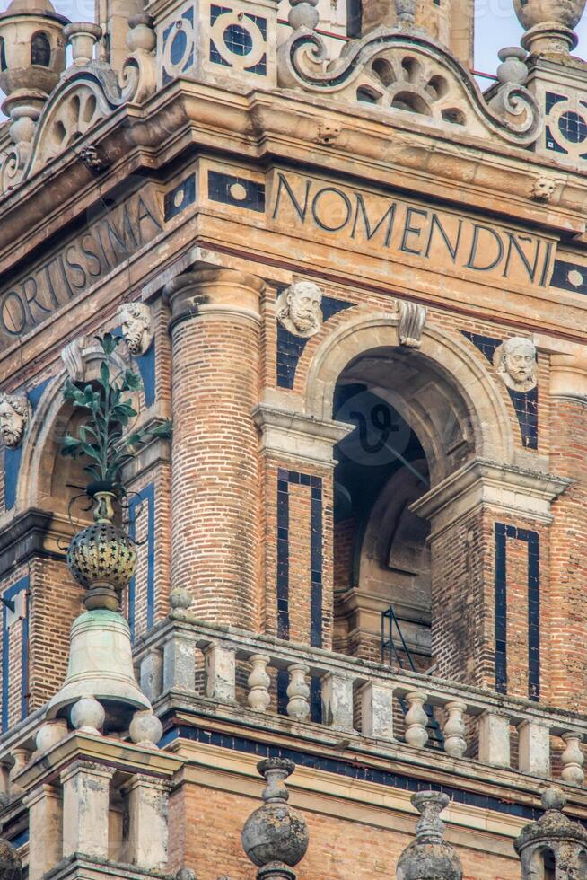 Detailed View of Giralda Bell Tower with Latin Inscriptions in Seville, Spain photo
