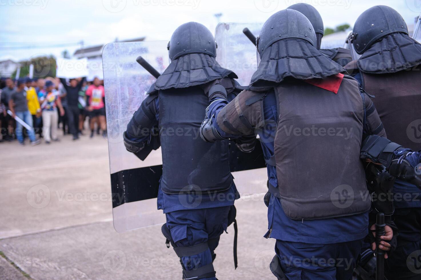 Riot police control the crowd.. photo