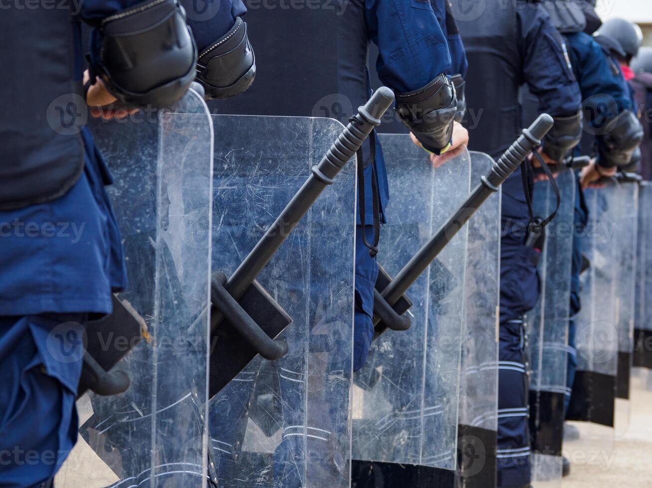 Riot police control the crowd.. photo