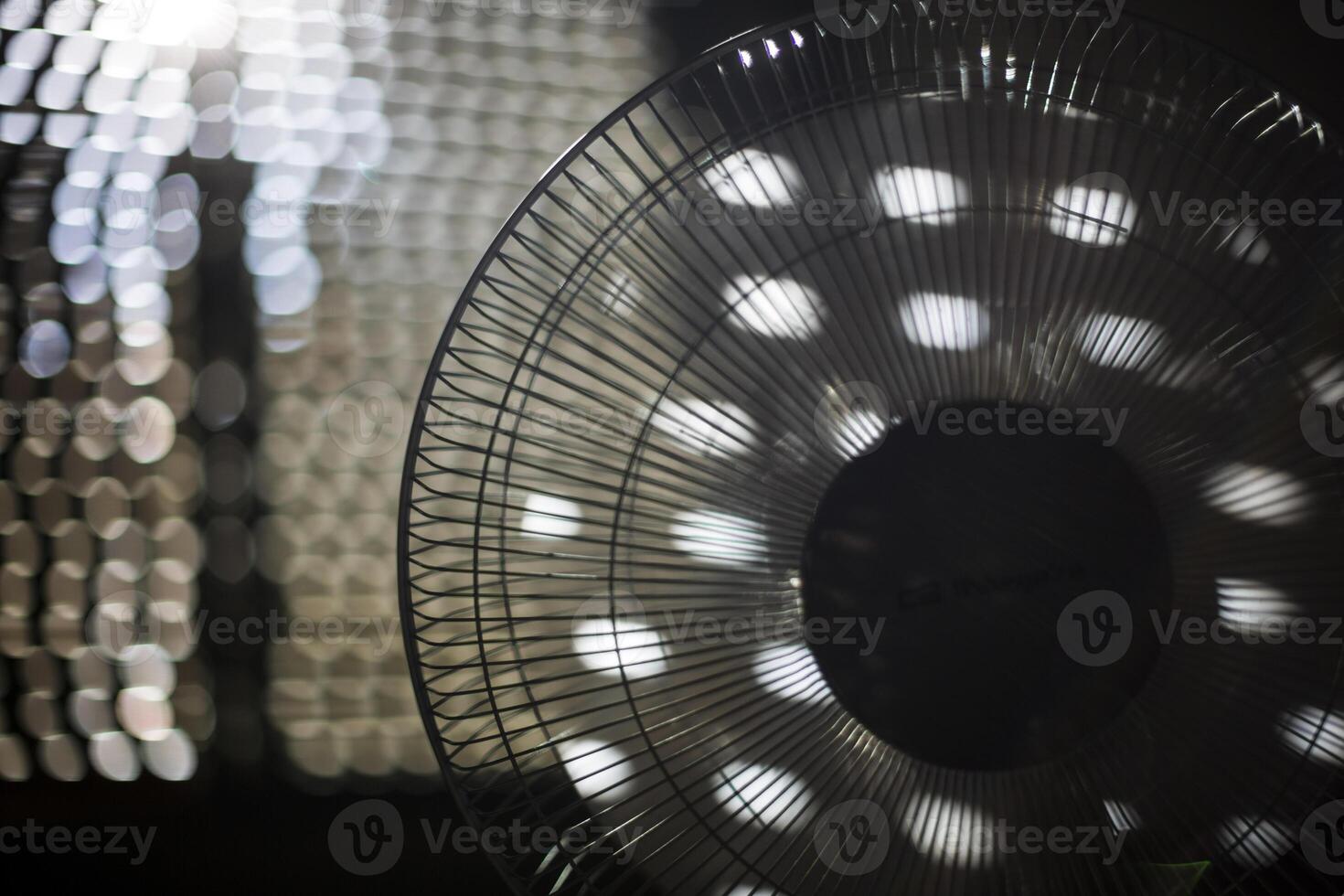 Fan working indoors on a hot summer day photo