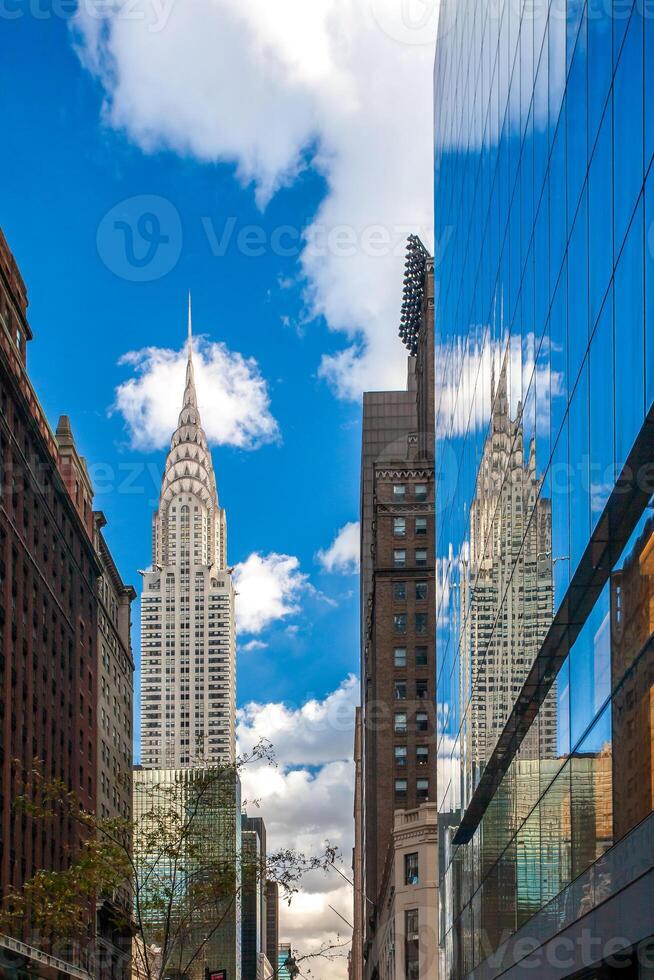 The Chrysler Building reflected on a glass building on 42th street photo