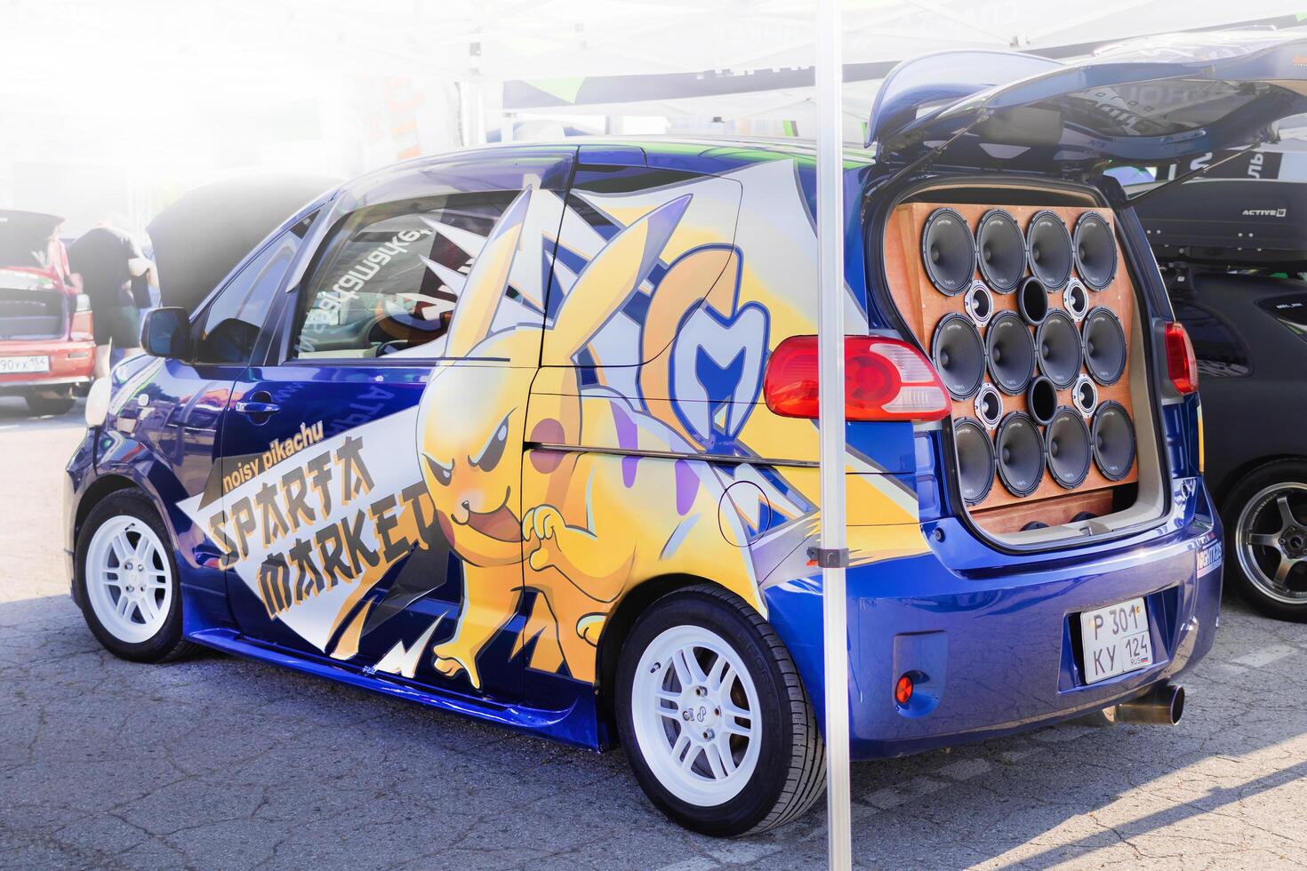 Russia, Novosibirsk, 23.06.2024, toyota porte with pikachu sticker and powerful audio speakers are installed in the trunk of the car. side view photo