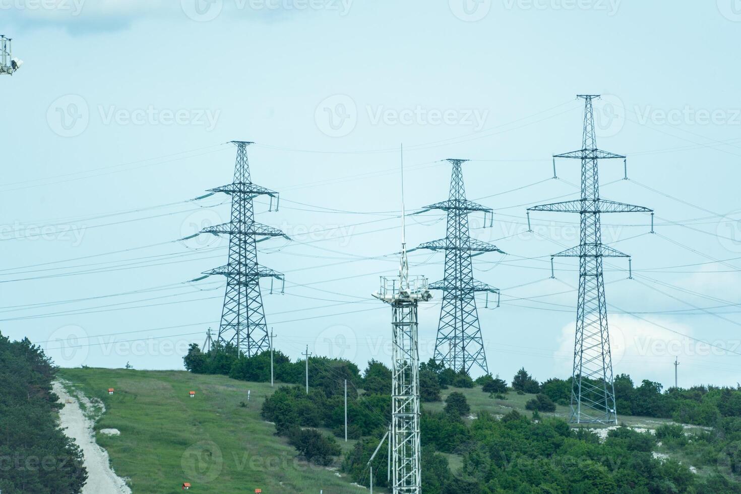 High voltage towers with sky background. Power line support with wires for electricity transmission. High voltage grid tower with wire cable at distribution station. Energy industry, energy saving photo