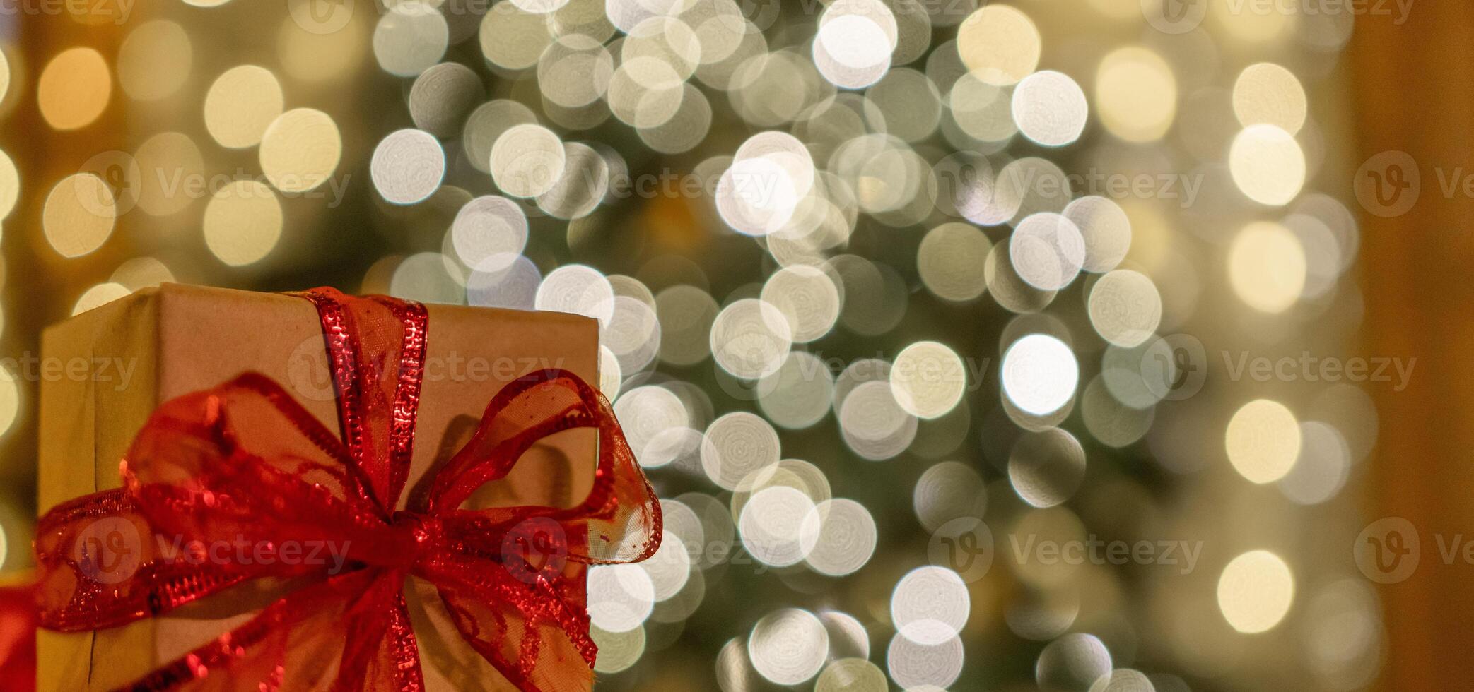 Christmas gift or present box, against magic bokeh background. Beautiful Christmas gift boxes with ribbon photo