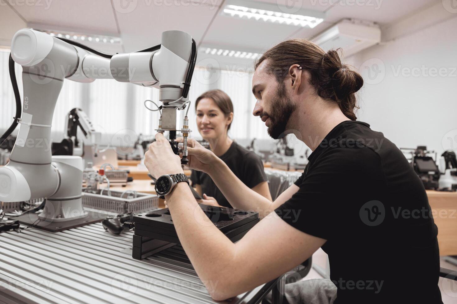 Industrial Robotics program university students learning education mechanical assembly with Robot Universal Training Platform robot arm simulation model in engineering lab classroom. photo
