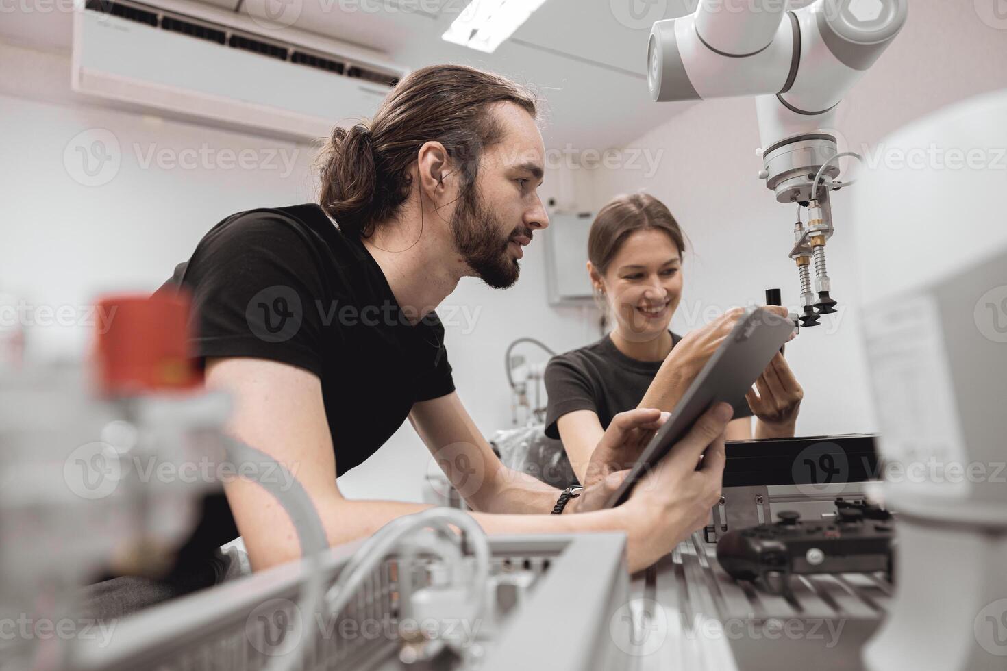 Industrial Robotics program university students learning education mechanical assembly with Robot Universal Training Platform robot arm simulation model in engineering lab classroom. photo