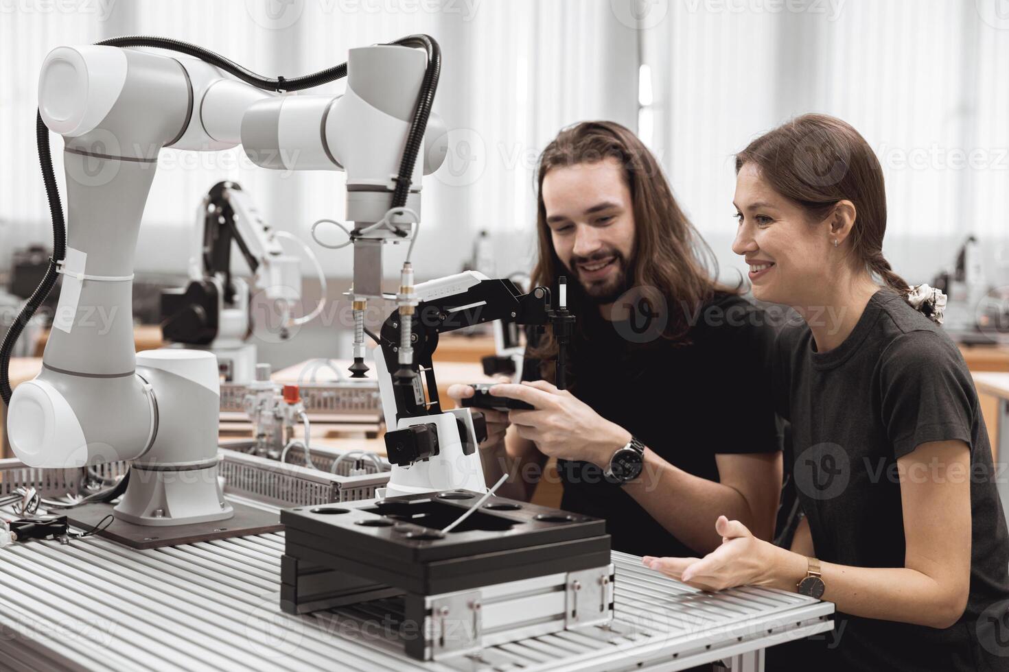 Industrial Robotics program university students learning education mechanical assembly with Robot Universal Training Platform robot arm simulation model in engineering lab classroom. photo