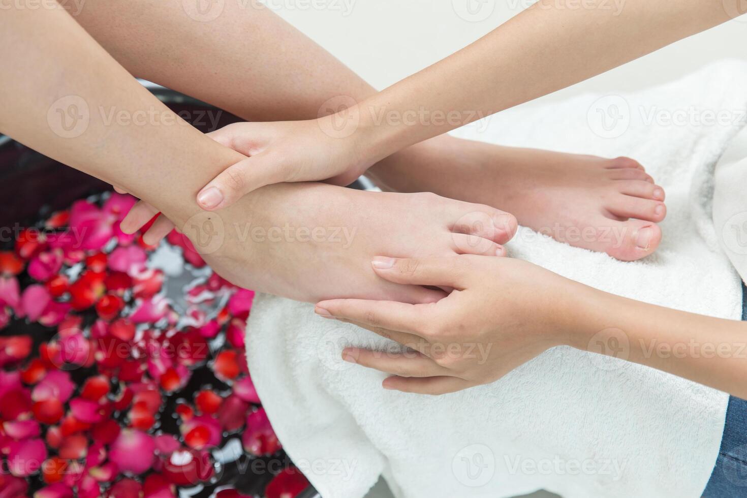 foot massage hand pressing sole spot pain relief feet care beauty cosmetic process in spa salon photo