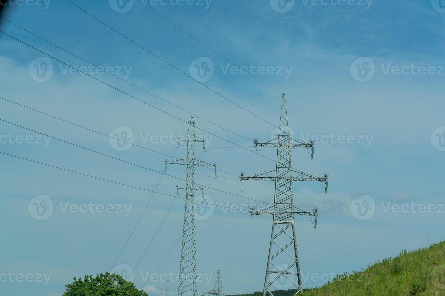 High voltage towers with sky background. Power line support with wires for electricity transmission. High voltage grid tower with wire cable at distribution station. Energy industry, energy saving photo