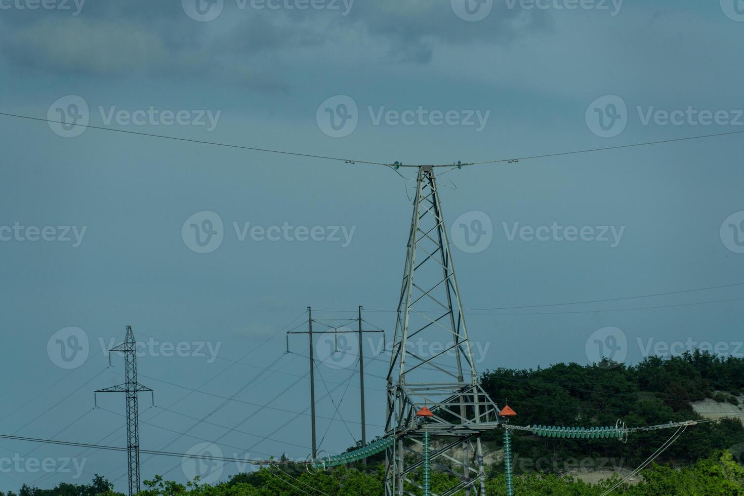High voltage towers with sky background. Power line support with wires for electricity transmission. High voltage grid tower with wire cable at distribution station. Energy industry, energy saving photo