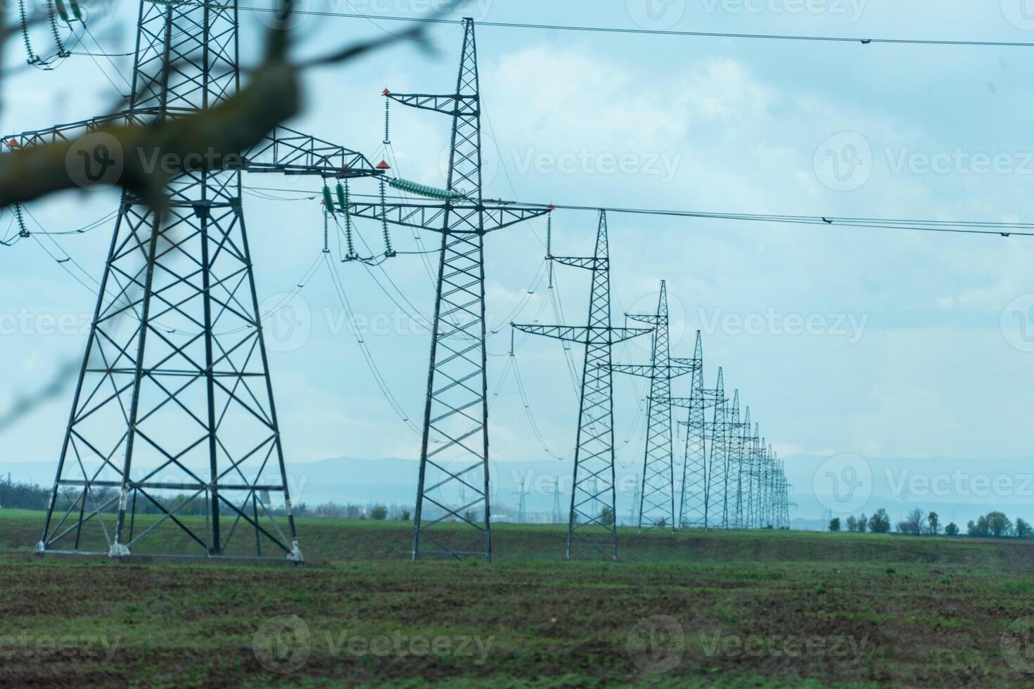 High voltage towers with sky background. Power line support with wires for electricity transmission. High voltage grid tower with wire cable at distribution station. Energy industry, energy saving photo
