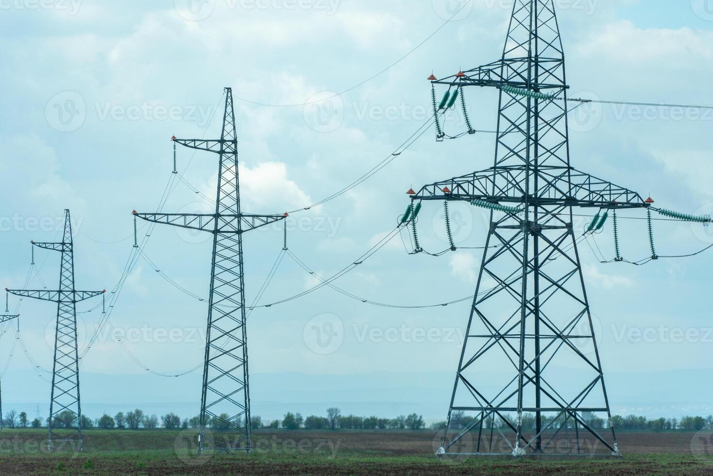 High voltage towers with sky background. Power line support with wires for electricity transmission. High voltage grid tower with wire cable at distribution station. Energy industry, energy saving photo