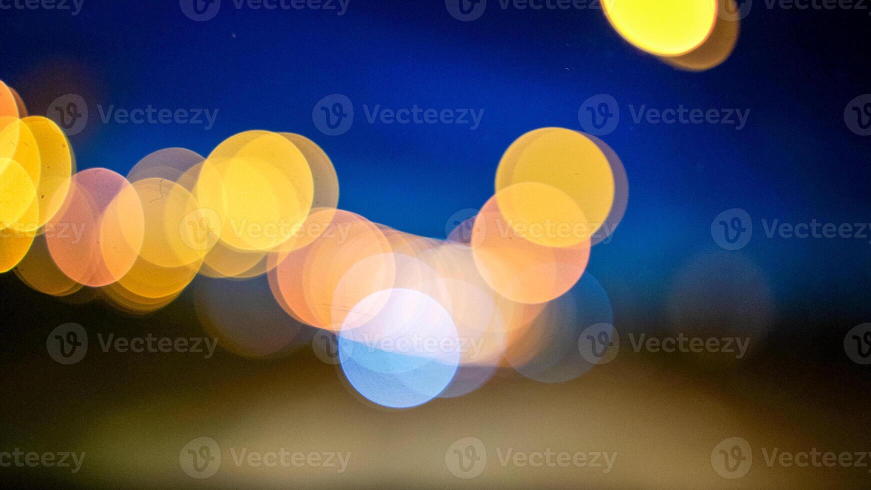 Blurred lights evening city traffic bokeh. Defocused night city traffic. Blurred lights bokeh car headlights driving evening city road. City night traffic background photo