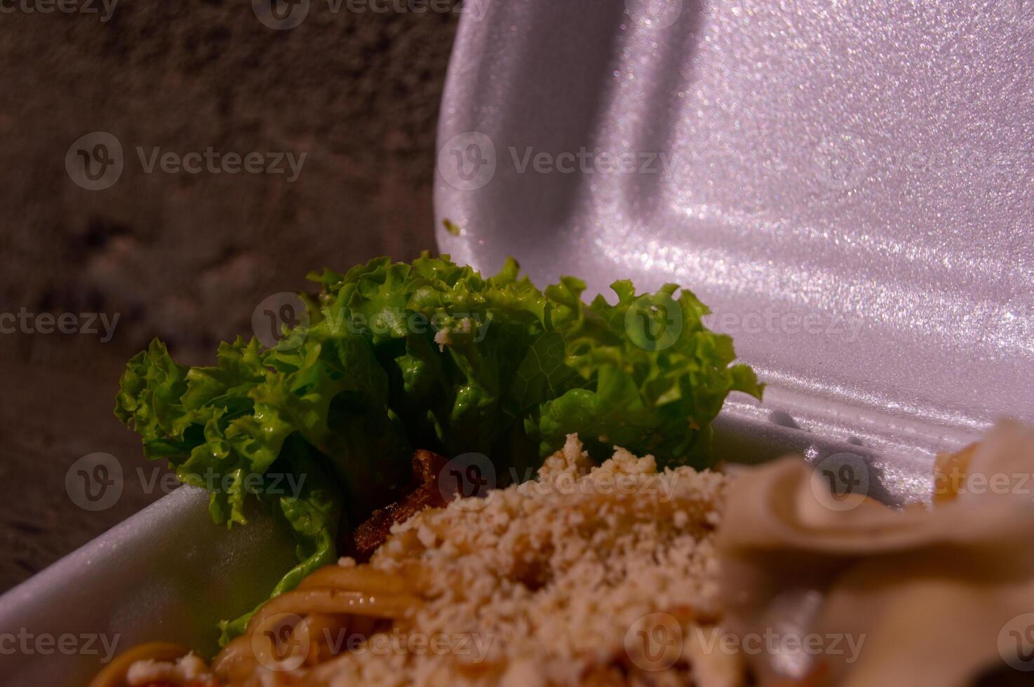 noodle dish from Indonesia, with spices and a mixture of sweet soy sauce. as well as toppings and vegetables. Noodles are sold in Styrofoam boxes photo