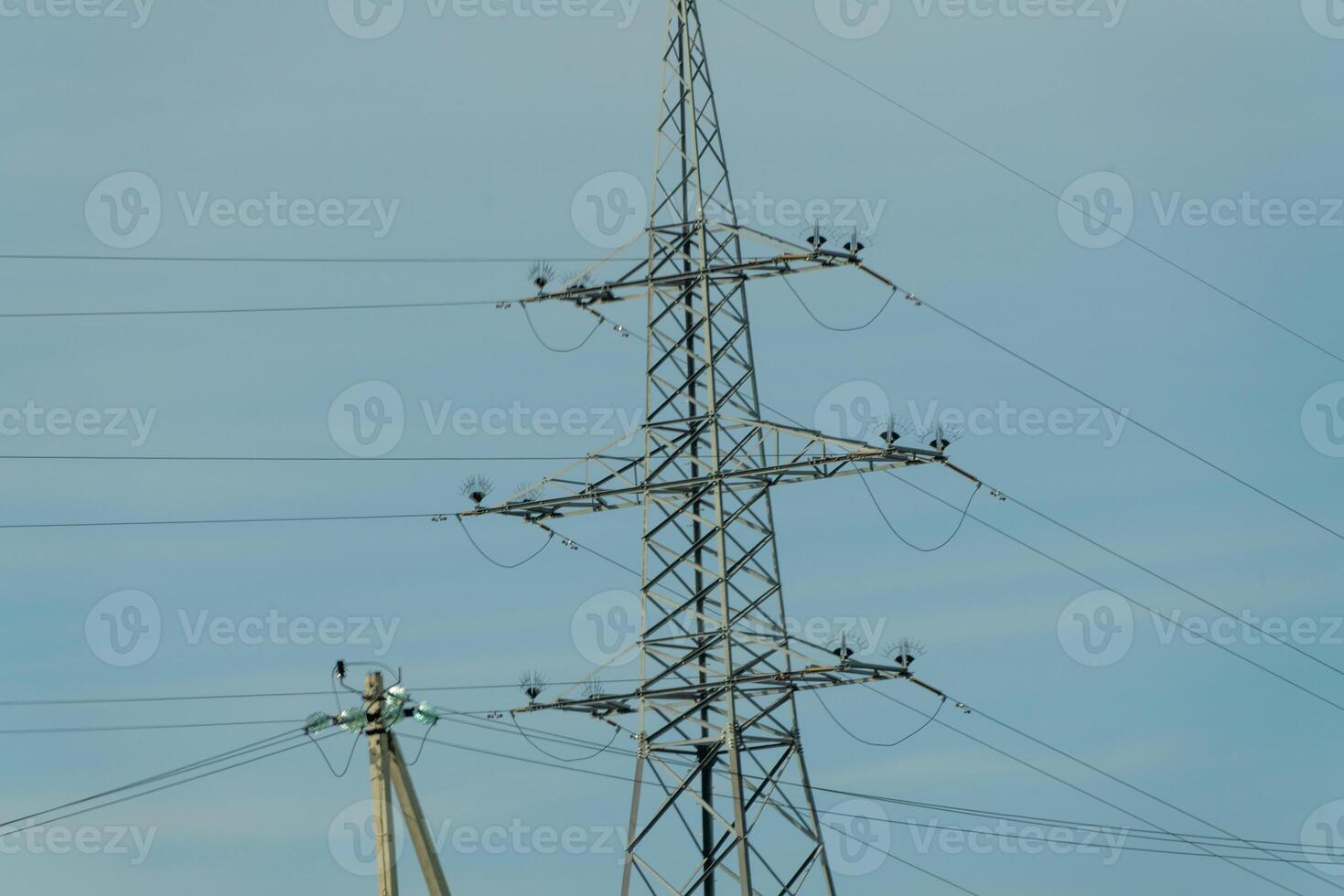 High voltage towers with sky background. Power line support with wires for electricity transmission. High voltage grid tower with wire cable at distribution station. Energy industry, energy saving photo