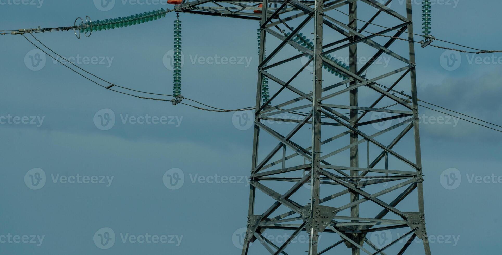 High voltage towers with sky background. Power line support with wires for electricity transmission. High voltage grid tower with wire cable at distribution station. Energy industry, energy saving photo
