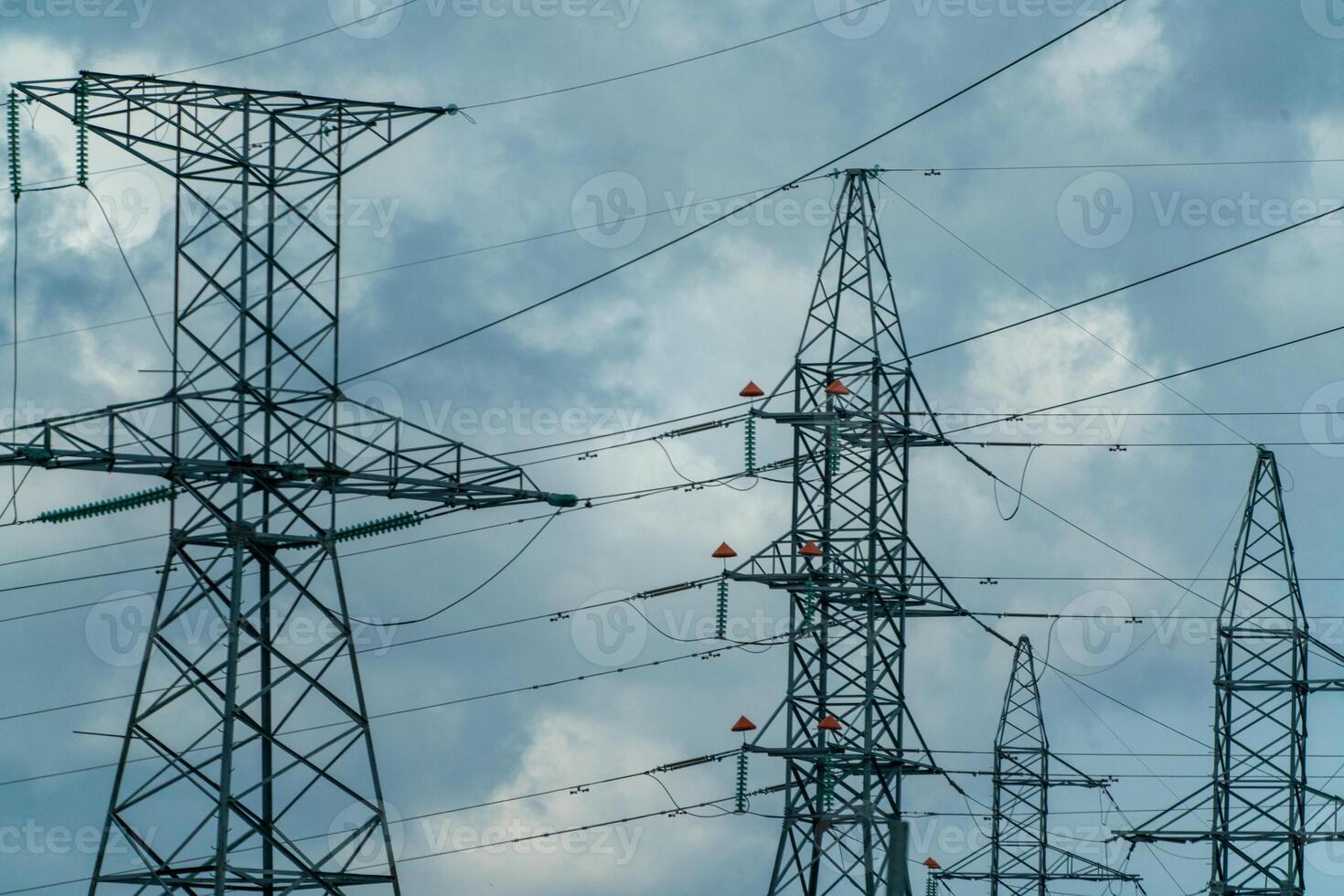 High voltage towers with sky background. Power line support with wires for electricity transmission. High voltage grid tower with wire cable at distribution station. Energy industry, energy saving photo