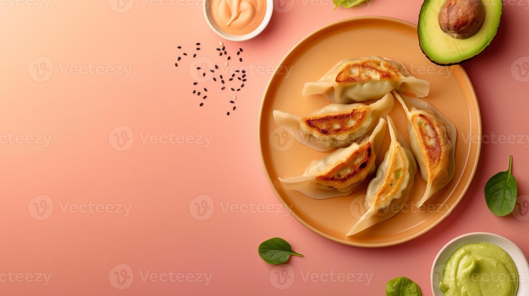 Flat lay gyoza with sauce, avocado slice and leaf copy space isolated photo