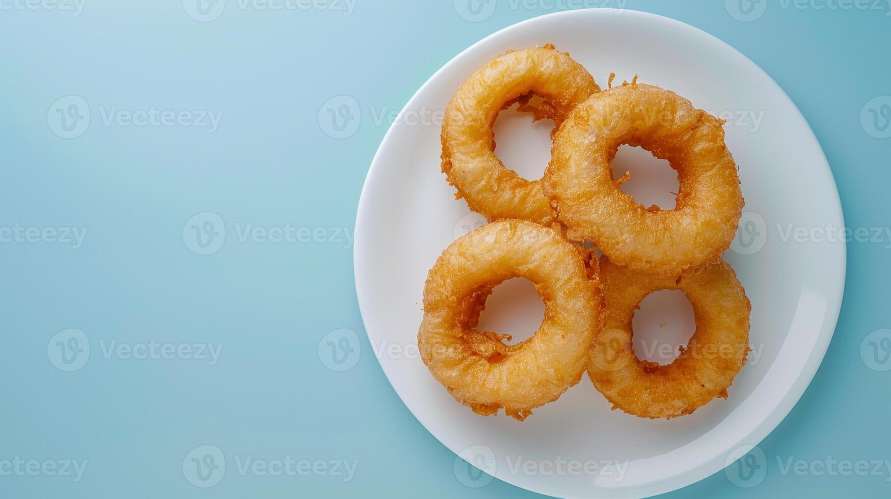 Flat lay fried onion ring salty snack crunchy on white plate copy space isolated photo