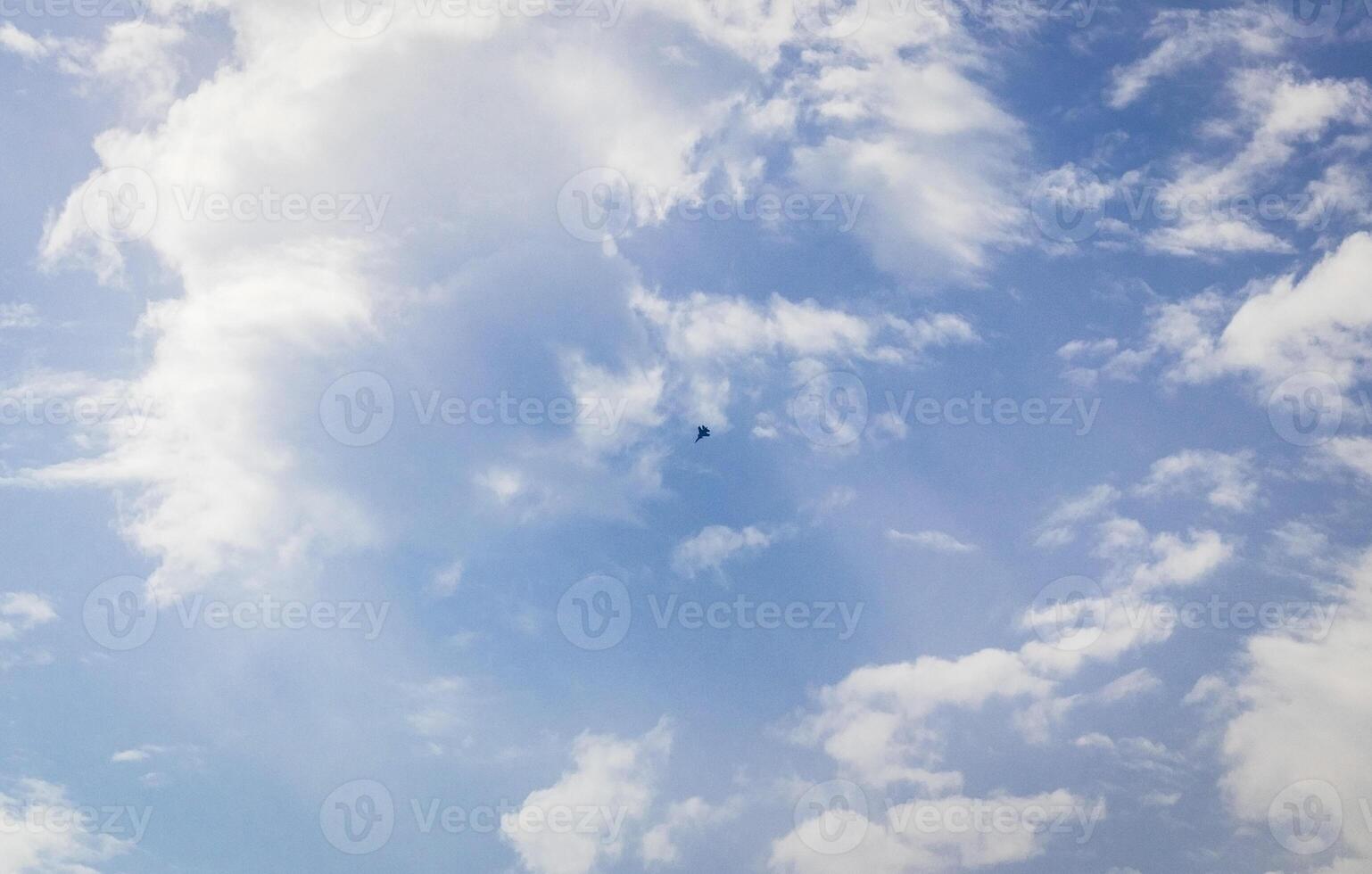 Silhouette of the MIG fighter jet in the cloudy sky. Military photo