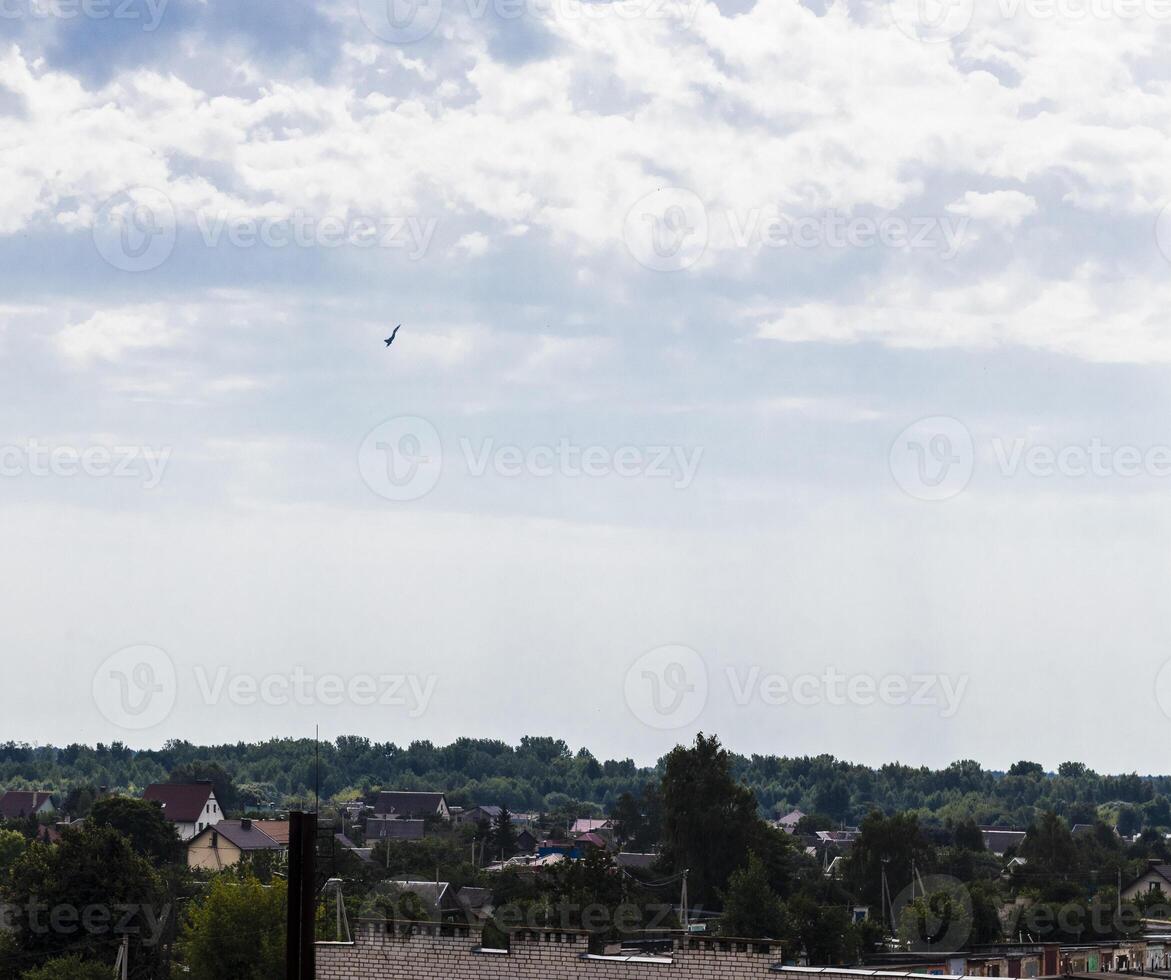 Silhouette of the MIG fighter jet in the cloudy sky. Military photo