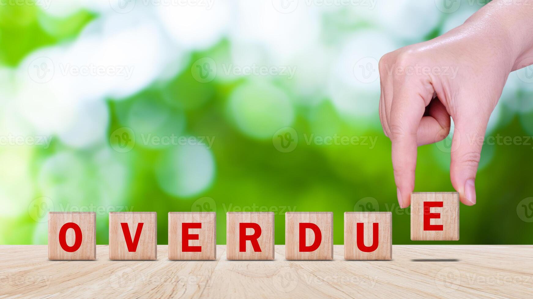 Overdue, Wooden on the office desk, informative and communication background, Word OVERDUE made with wood building blocks, OVERDUE word on block concept. photo