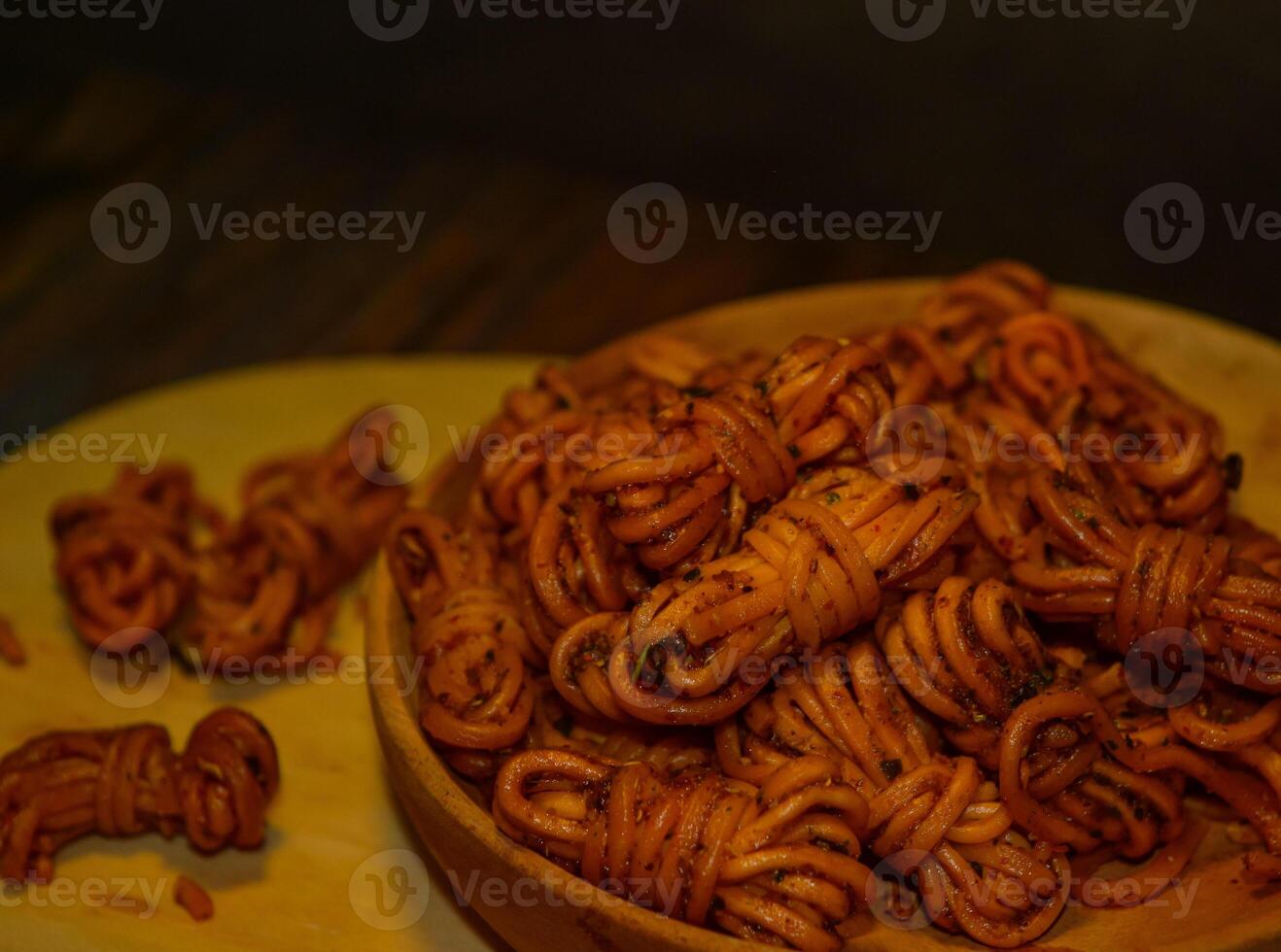 Mie gulung kering is a snack made from wheat flour and tapioca sprinkled with powdered spices. There are spicy, cheesy and original flavors. photo