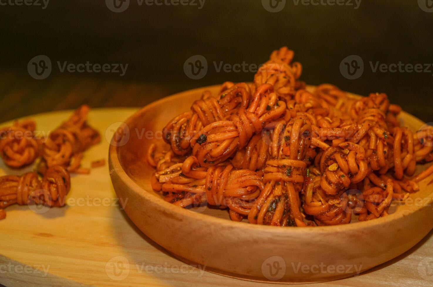 Mie gulung kering is a snack made from wheat flour and tapioca sprinkled with powdered spices. There are spicy, cheesy and original flavors. photo