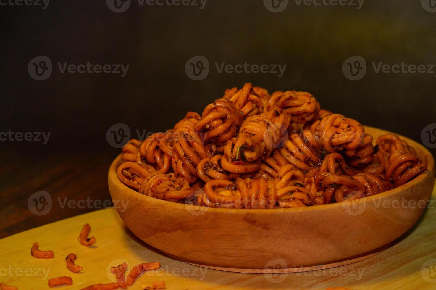 Mie gulung kering is a snack made from wheat flour and tapioca sprinkled with powdered spices. There are spicy, cheesy and original flavors. photo