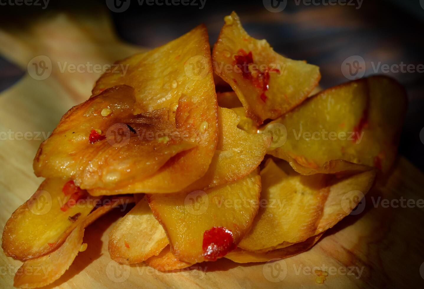 Keripik Singkong pedas or spicy Cassava Chips, Indonesian traditional snack. Made of cassava sliced, fried and cooked with chilli. photo