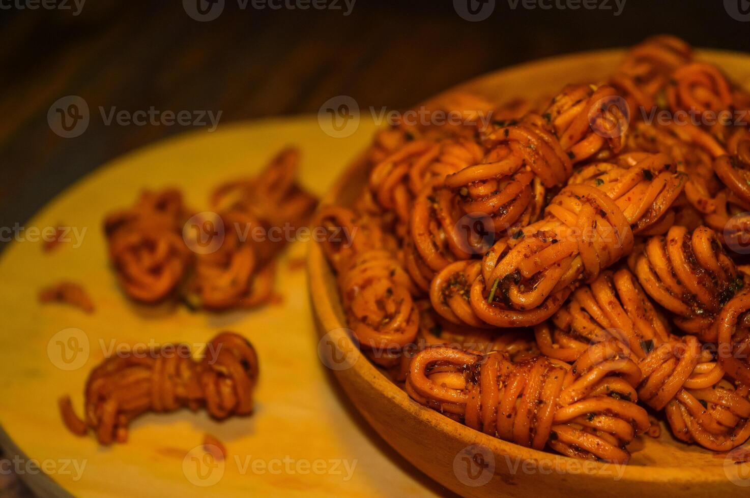 Mie gulung kering is a snack made from wheat flour and tapioca sprinkled with powdered spices. There are spicy, cheesy and original flavors. photo