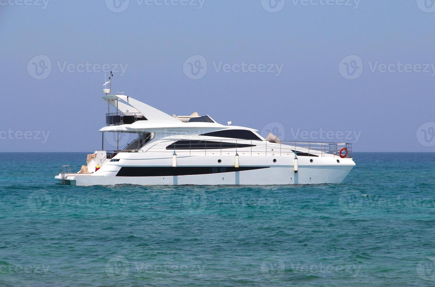 luxury white motor yacht sits far offshore in the Mediterranean Sea. Boat trip. Travel and recreation on the water. Ship in the blue sea, ocean photo