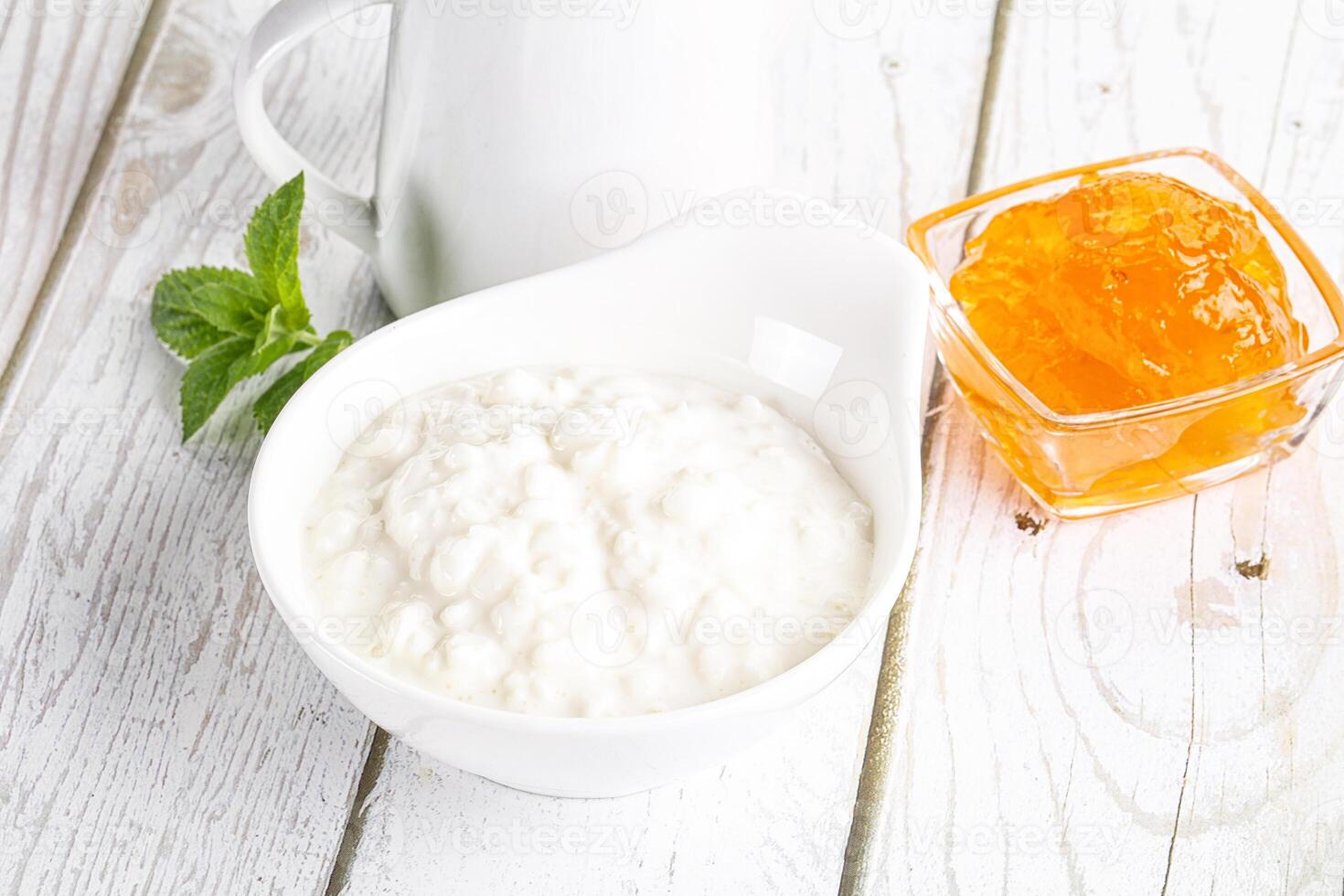 Grain curd with cream and jam photo