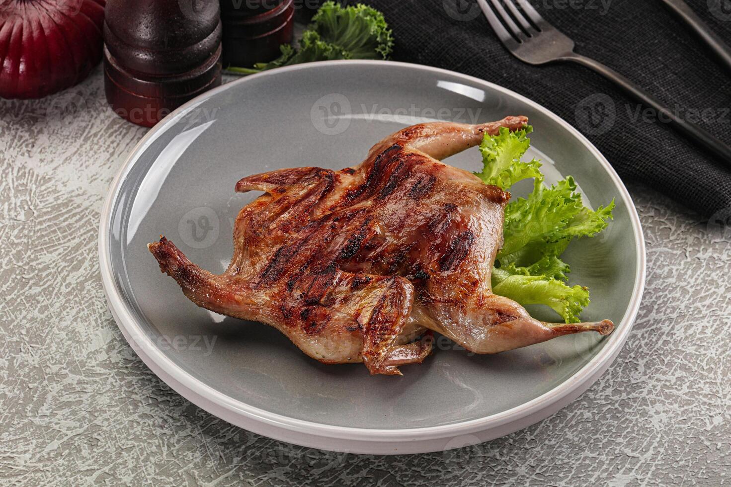 Grilled quail in the plate photo