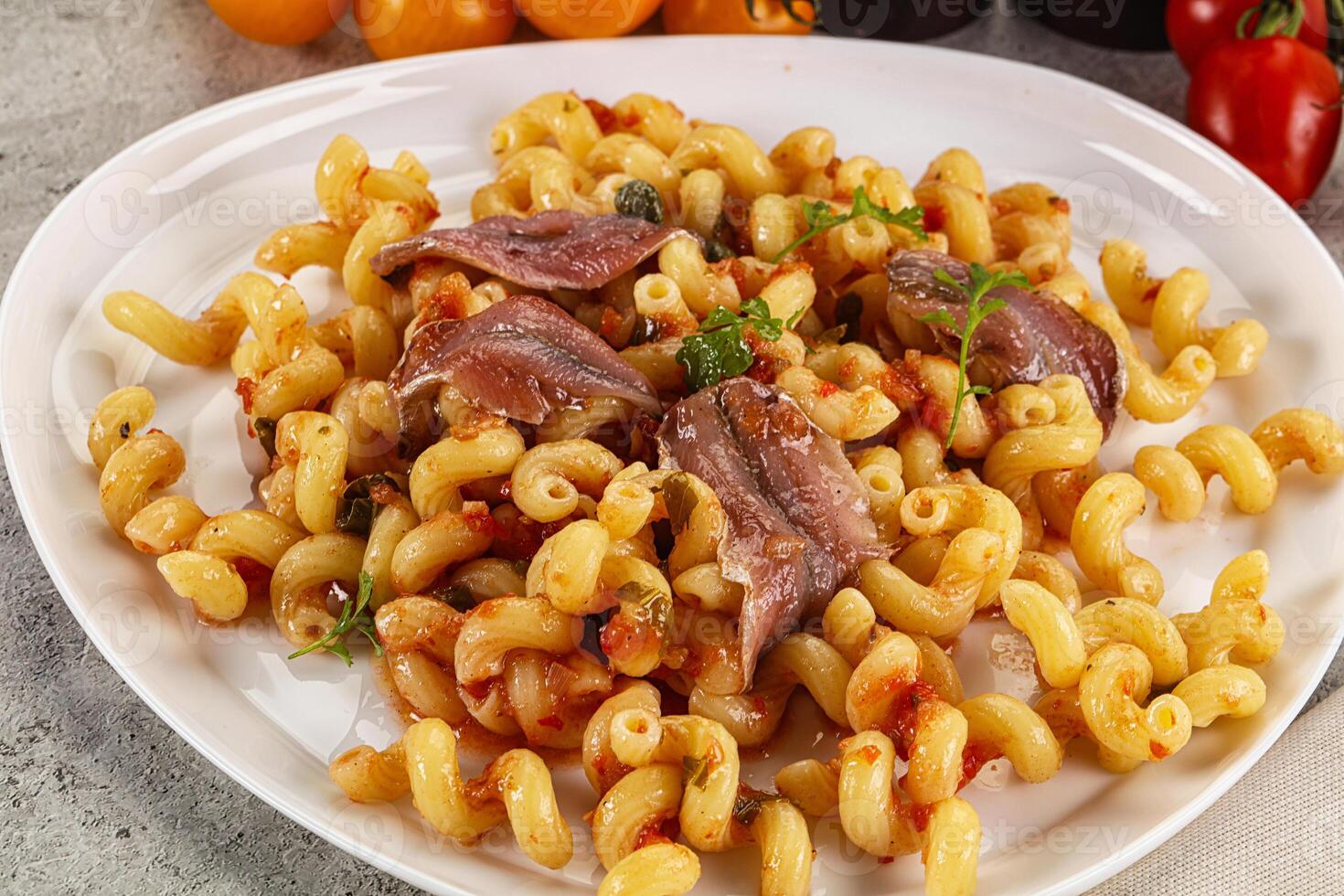 Italian pasta cellentani with anchovy photo