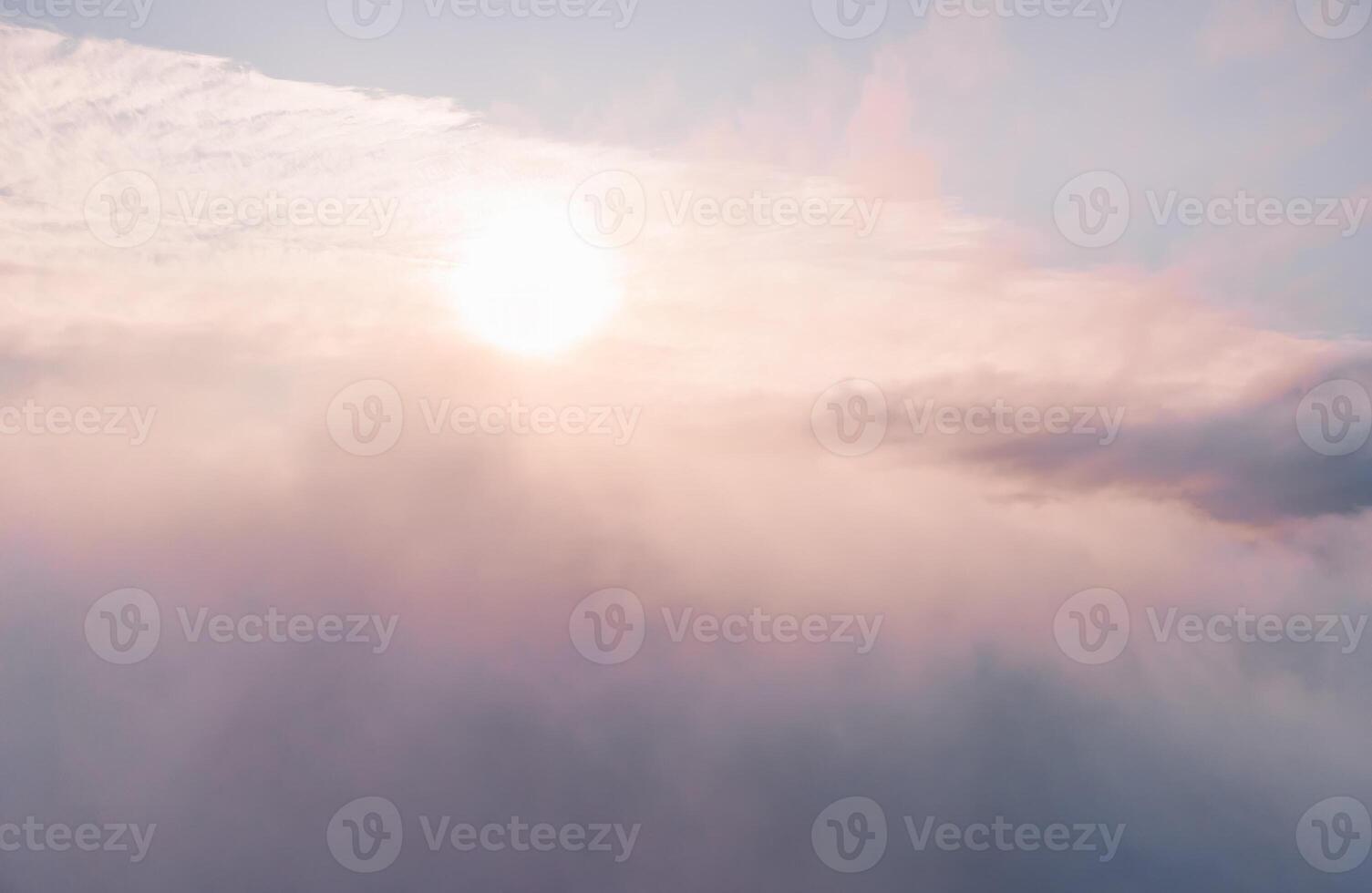 Aerial view. The drone flies over foggy and fluffy clouds. Blue sky sun and sea fog. Abstract aerial nature summer ocean sunset sea and sky background. Vacation, travel and holiday concept photo