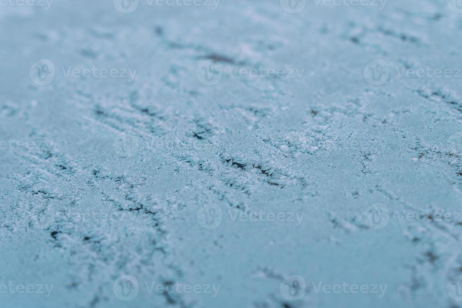 Selective focus. First frost on a frozen car, late autumn close-up. Beautiful abstract frozen microcosmos pattern. Freezing weather frost action in nature. Winter backdrop. photo