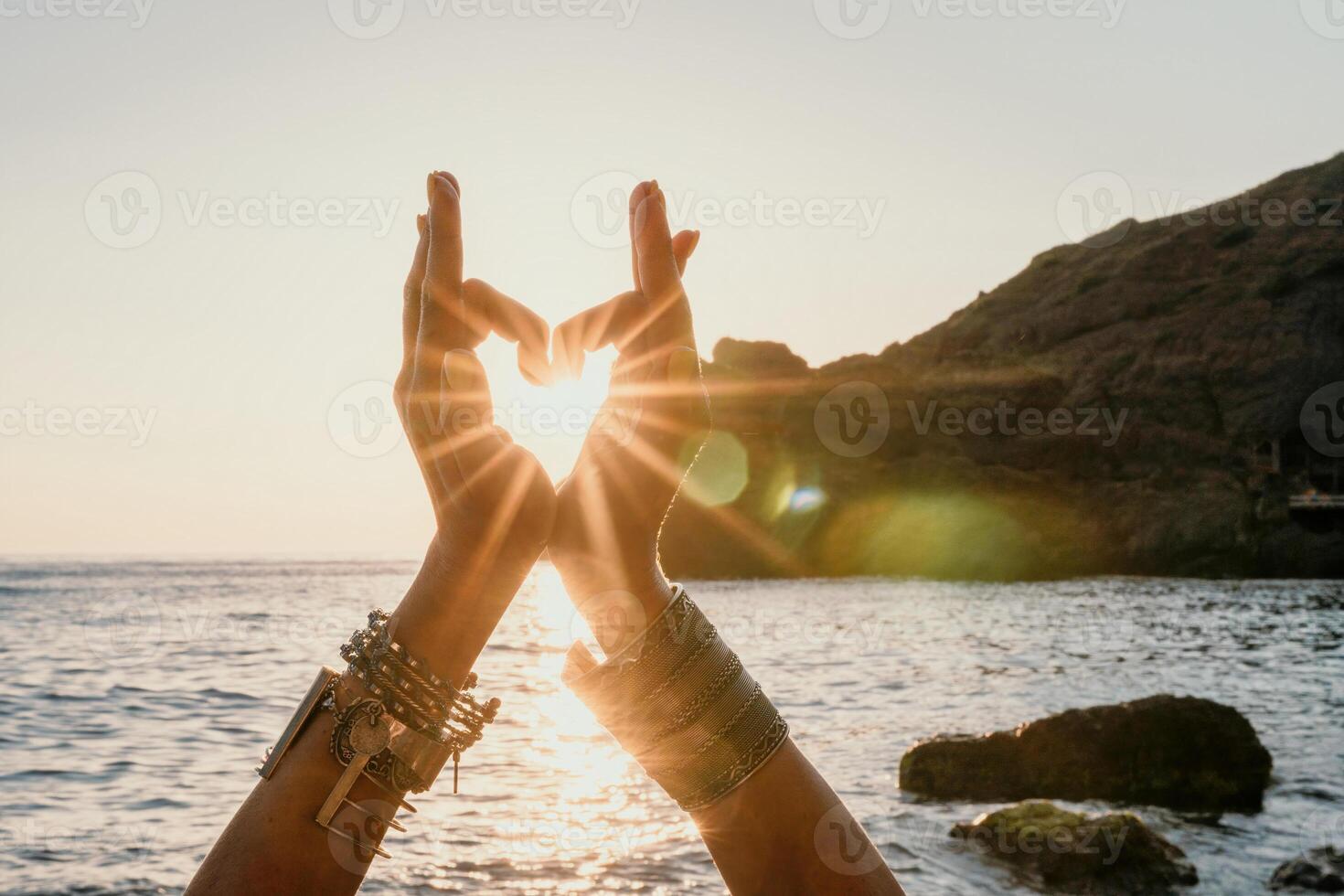 Woman sea yoga. Happy woman in white swimsuit and boho style braclets practicing outdoors on yoga mat by sea on sunset. Women yoga fitness routine. Healthy lifestyle, harmony and meditation photo