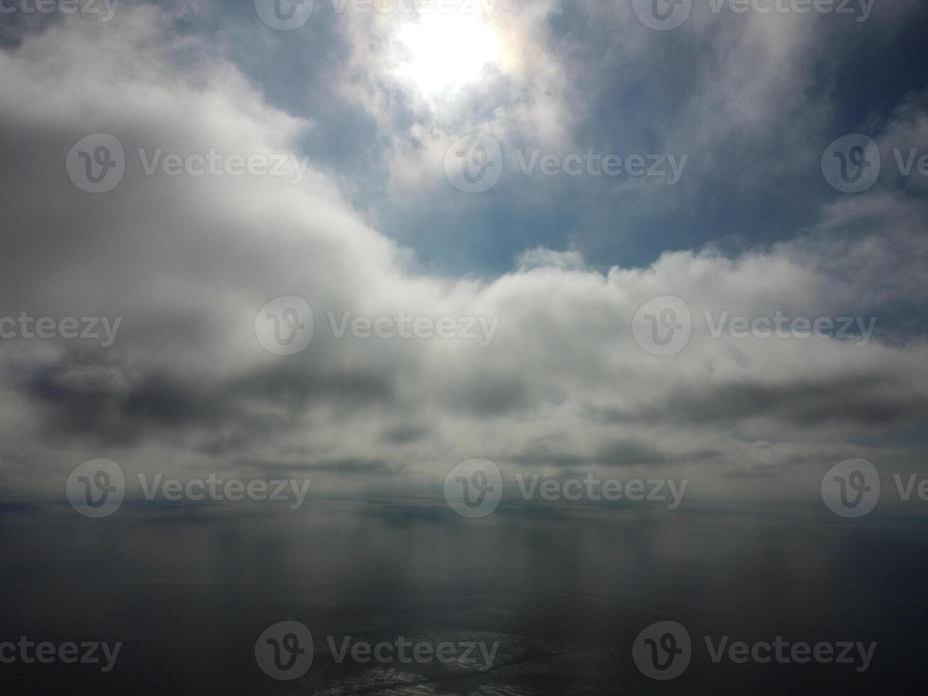 Aerial view. The drone flies over foggy and fluffy clouds. Blue sky sun and sea fog. Abstract aerial nature summer ocean sunset sea and sky background. Vacation, travel and holiday concept photo