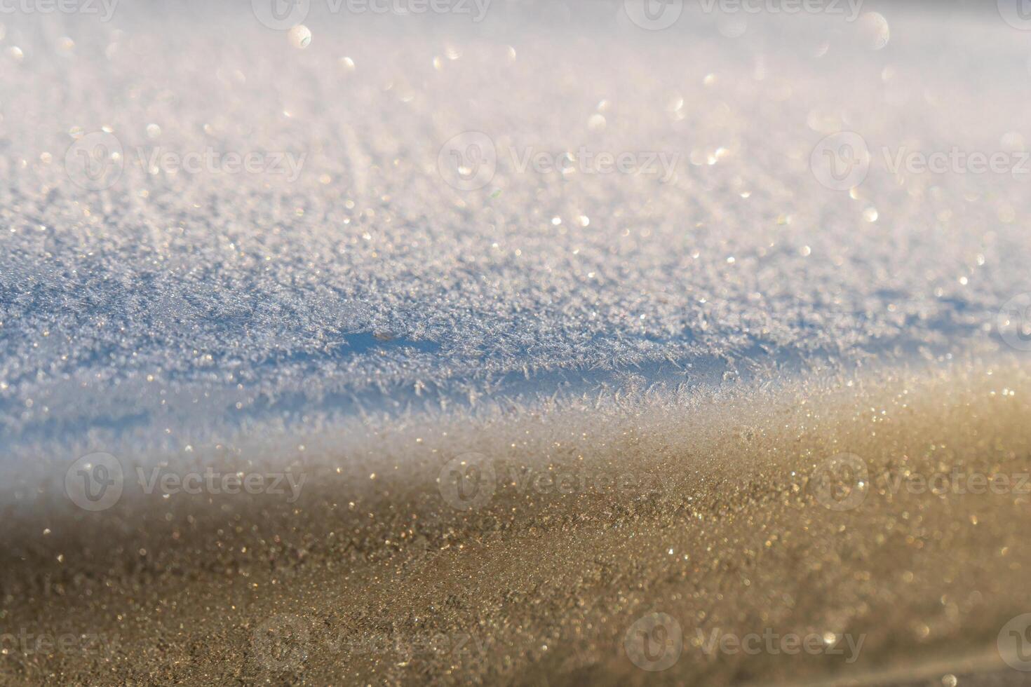 Selective focus. First frost on a frozen car, late autumn close-up. Beautiful abstract frozen microcosmos pattern. Freezing weather frost action in nature. Winter backdrop. photo